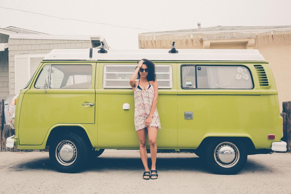 Free Image of Woman posing against green van 