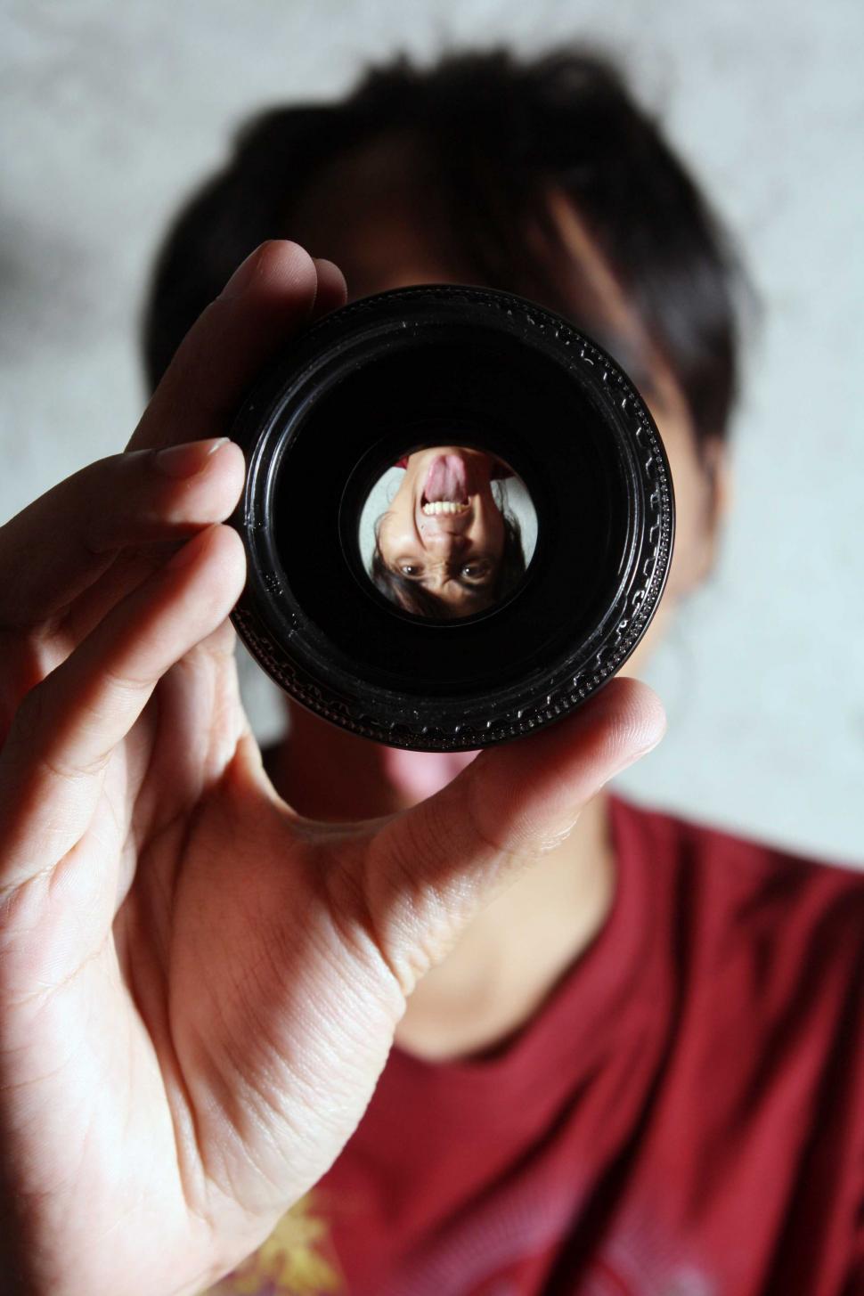Free Image of Upside Down Face in Camera Lens  