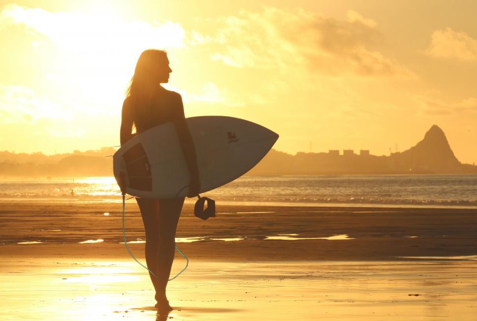 Free Image of Surfer Girl in yellow sunlight  