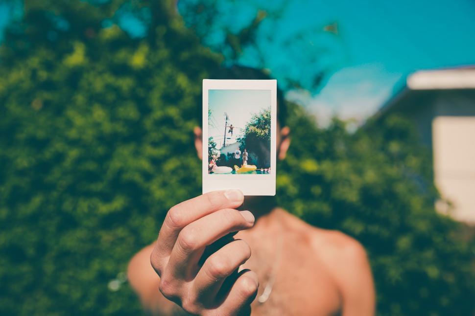 Free Image of Man Showing Picture  
