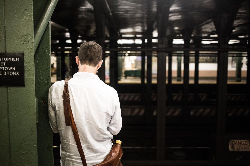 Free Image of Man in White Shirt at station 