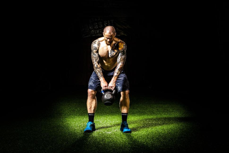 Free Image of Shirtless Man Lifting Dumbells 