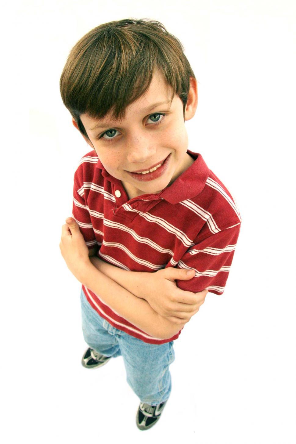 Free Image of Boy looking pleased with arms crossed 