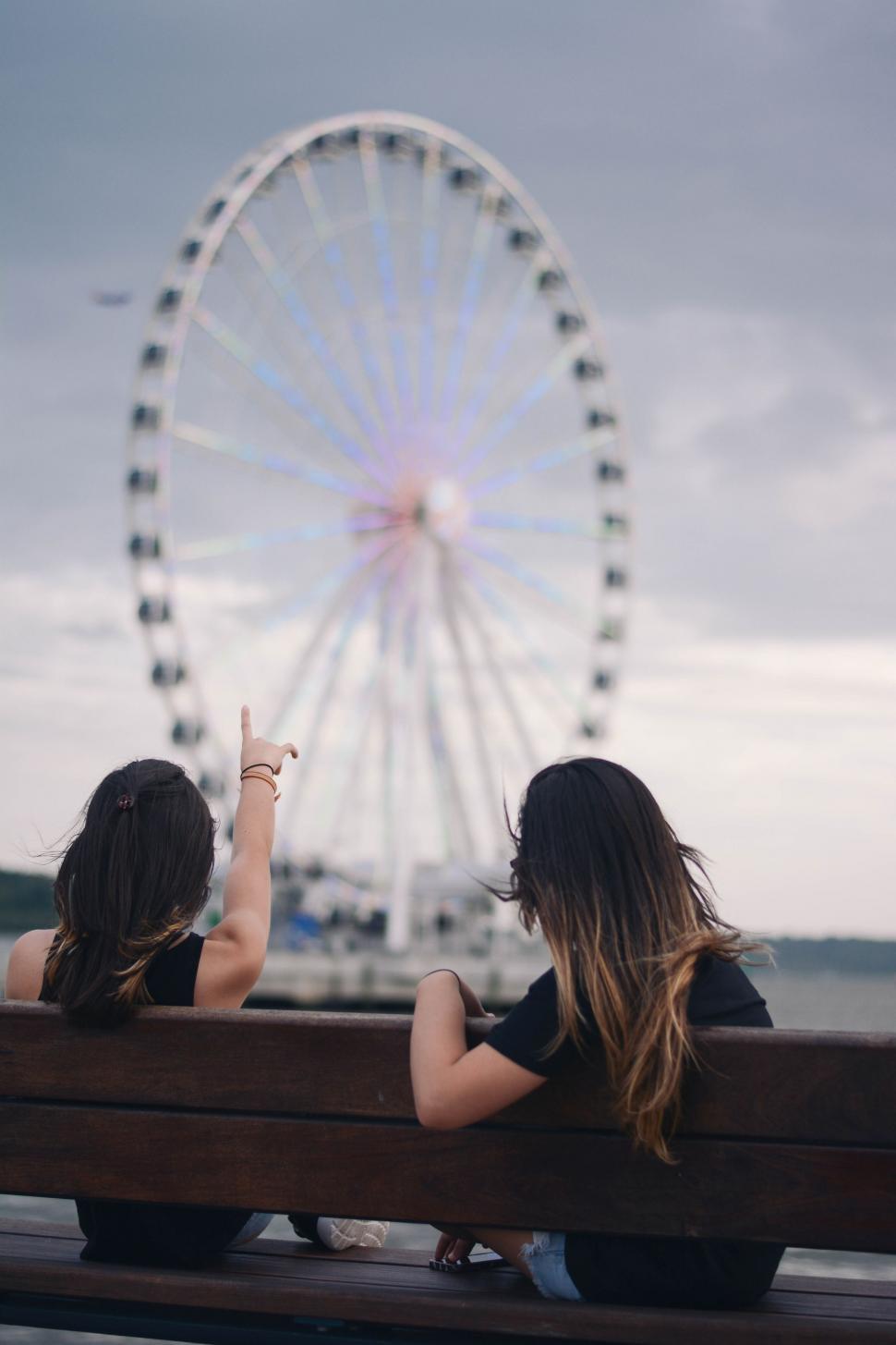 Free Image of Women Looking at Ferris Wheel  