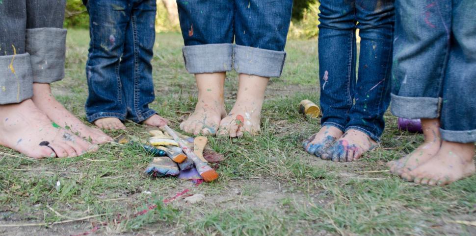Free Image of Paint Brushes and pairs of bare feet 