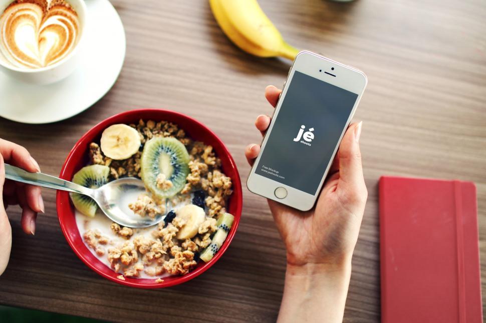 Free Image of Using Phone During Breakfast  