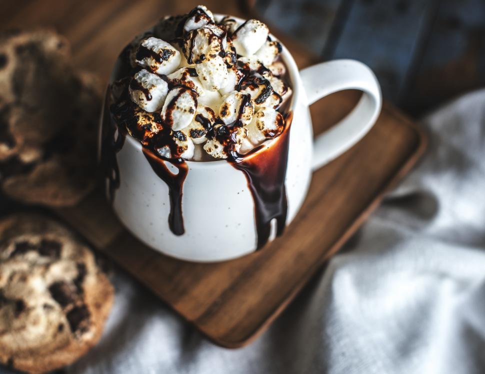 Free Image of Hot chocolate overflowing with marshmallows and chocolate sauce 