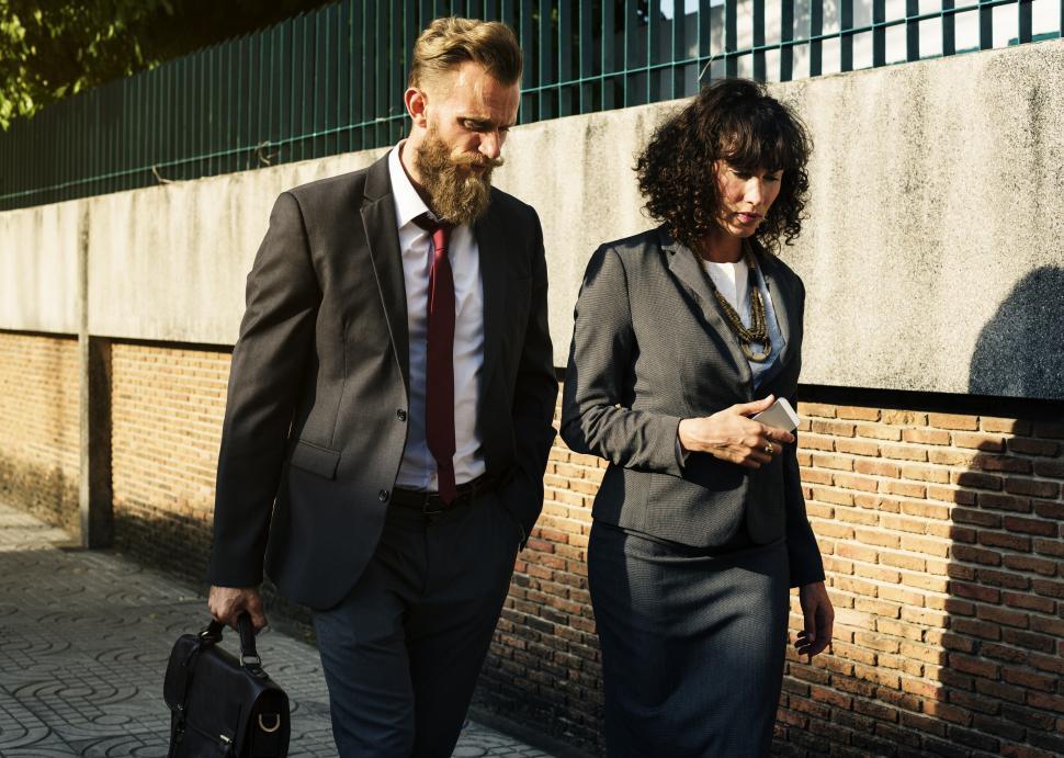 Free Image of Two business people talking while on a walk 