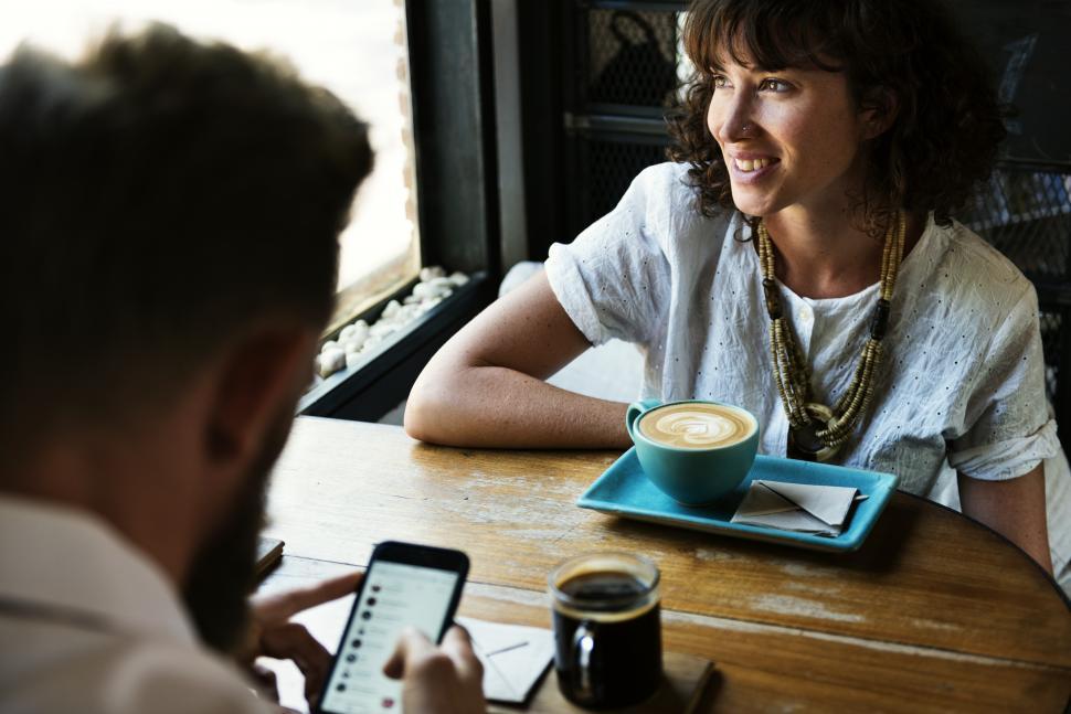 Free Image of Two business people discussing plans at a restaurant table 