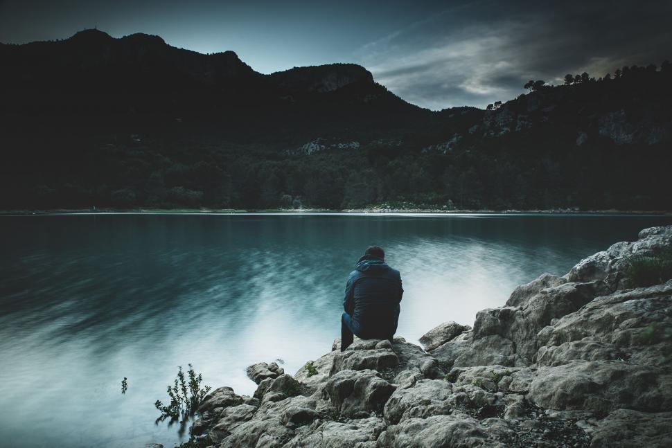 Free Image of Alone Man Sitting near river  