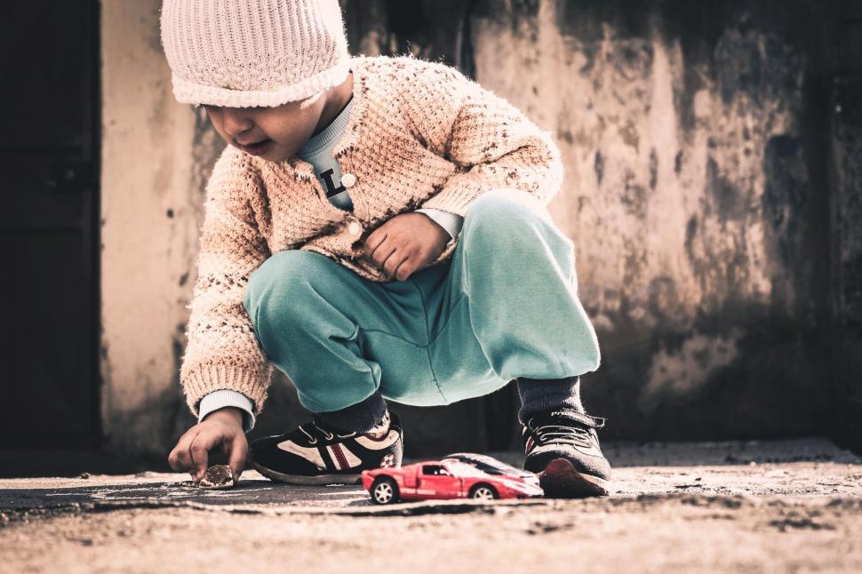 Free Image of Toddler Playing Car Toys  