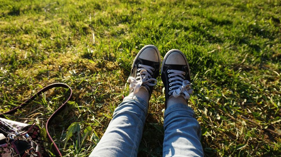 Free Image of Converse Shoes and Denim Feet  