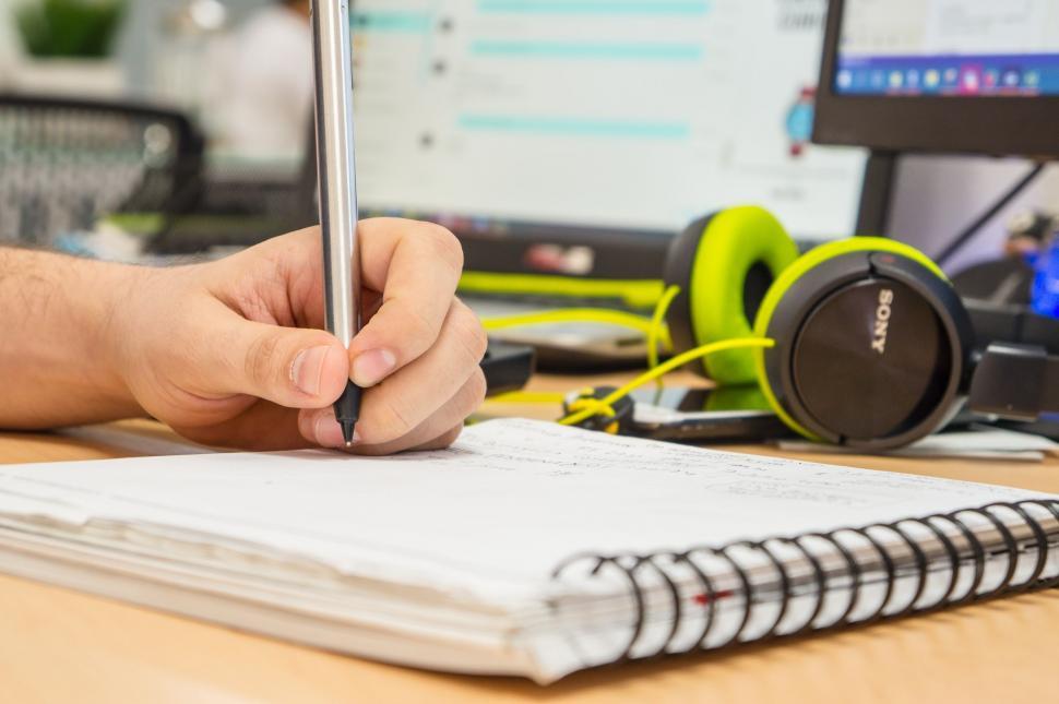 Free Image of Writing on Notebook  