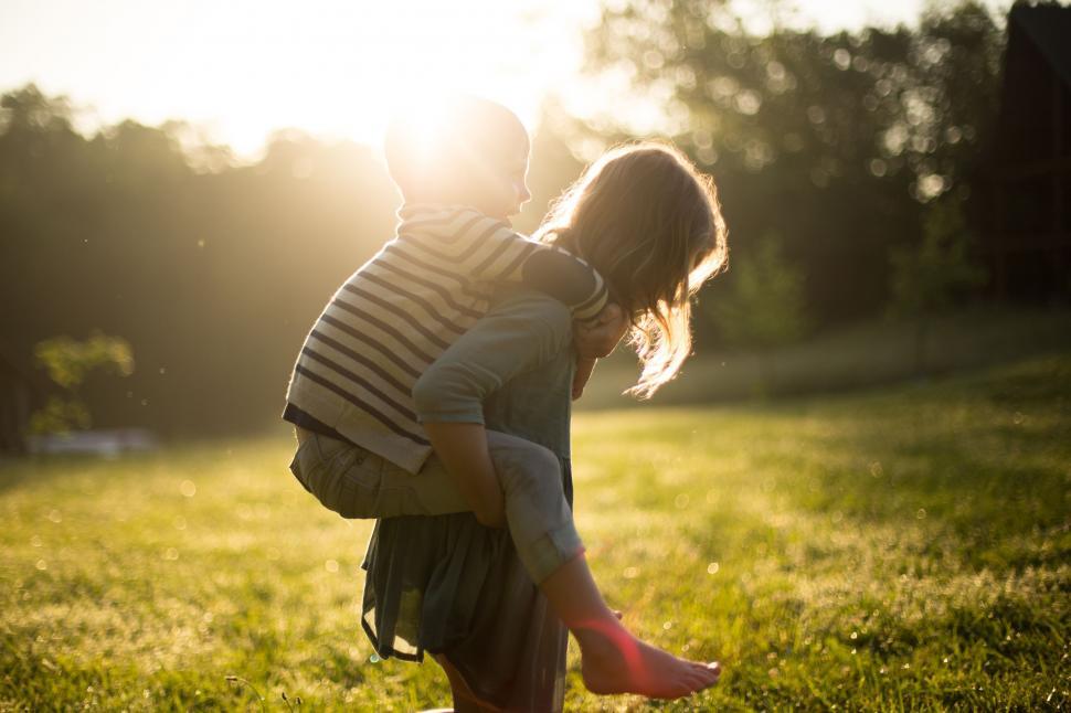 Free Image of Piggyback ride in Sunlight  