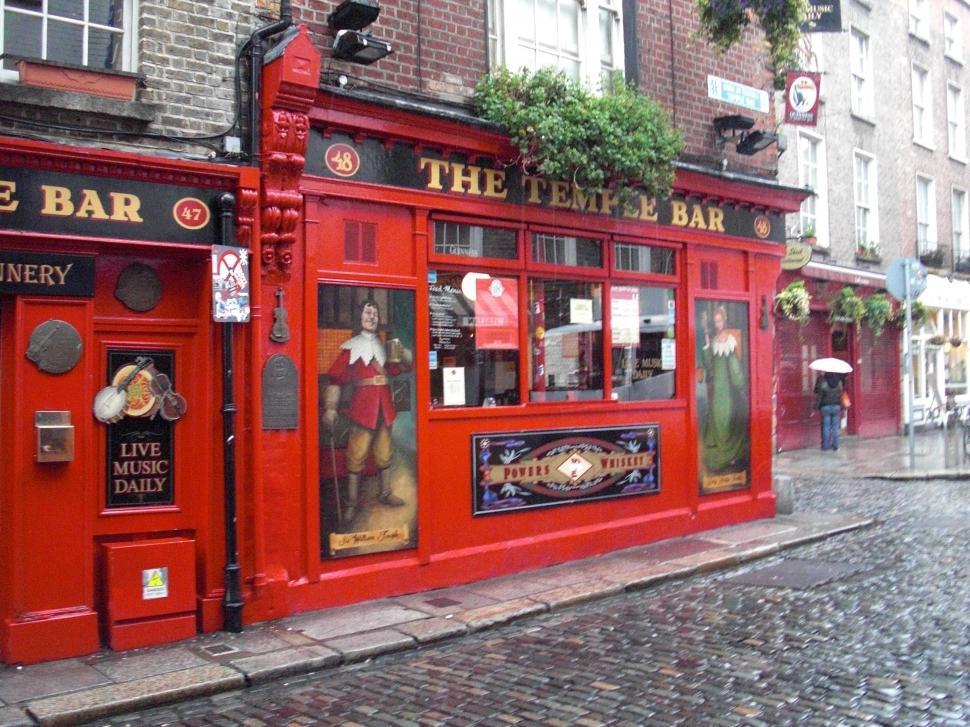 Free Image of Red Building on Cobblestone Street 