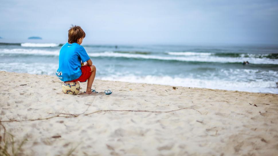 Free Image of Boy at beach with football 