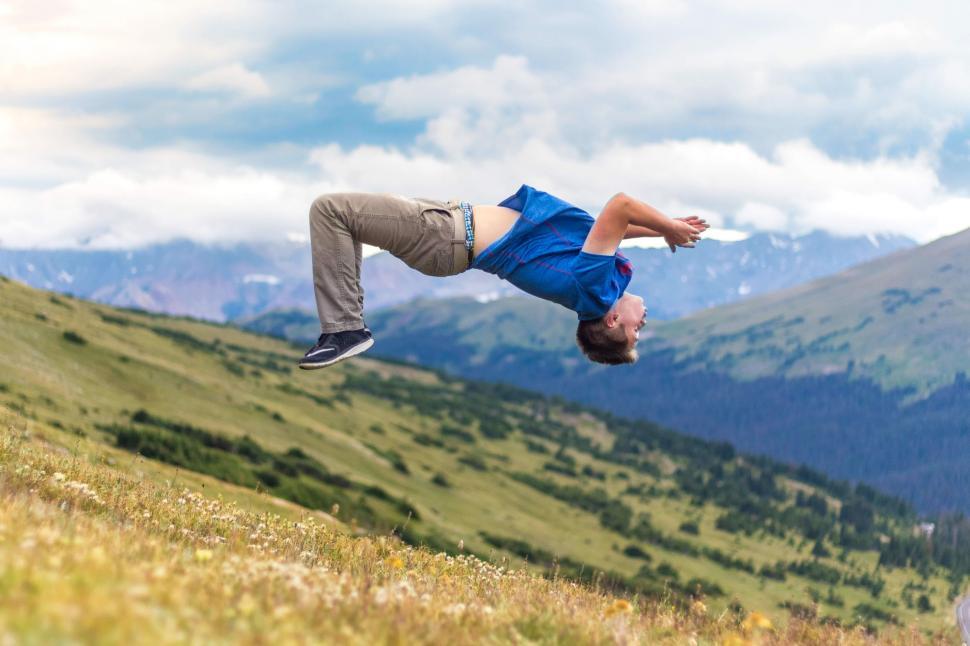 Free Image of Man Jumping on Mountain  