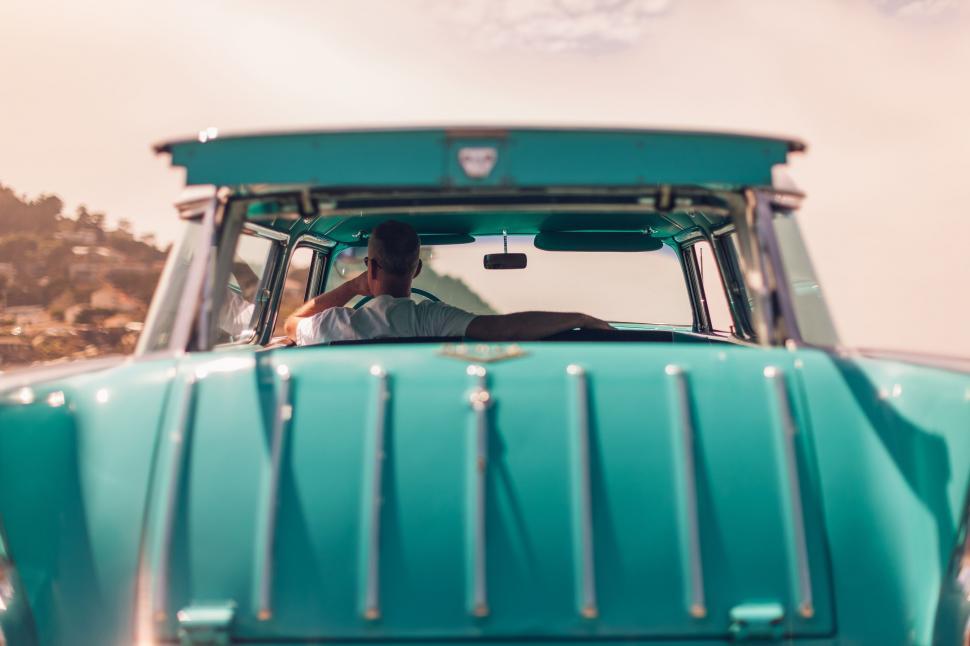 Free Image of Back side view of man driving a car 