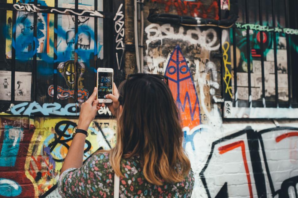 Free Image of Back Side view of woman taking a picture  