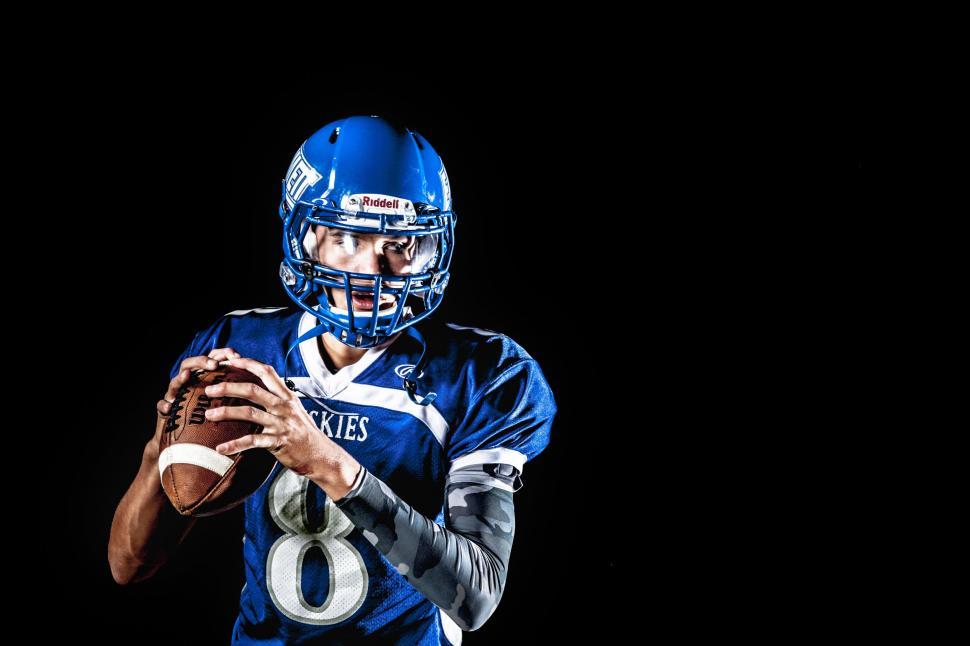 Free Image of American football player in helmet on black background  