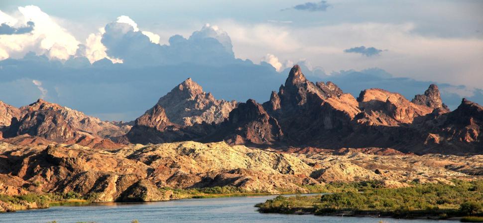 Free Image of Landscape view of mountains with river in front  