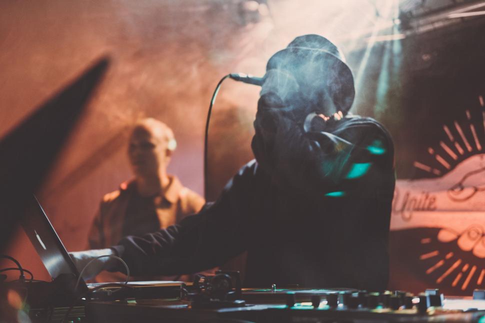 Free Image of DJ with sound mixer panel and laptop 