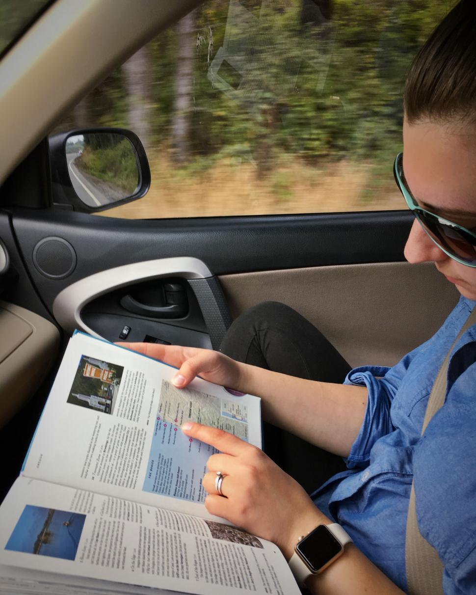 Free Image of Woman In Car with Magazine 
