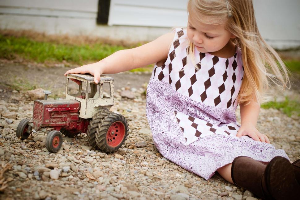 Free Image of Little Girl playing with toy  