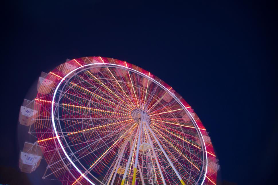 Free Image of Colorful Ferris wheel with black sky  