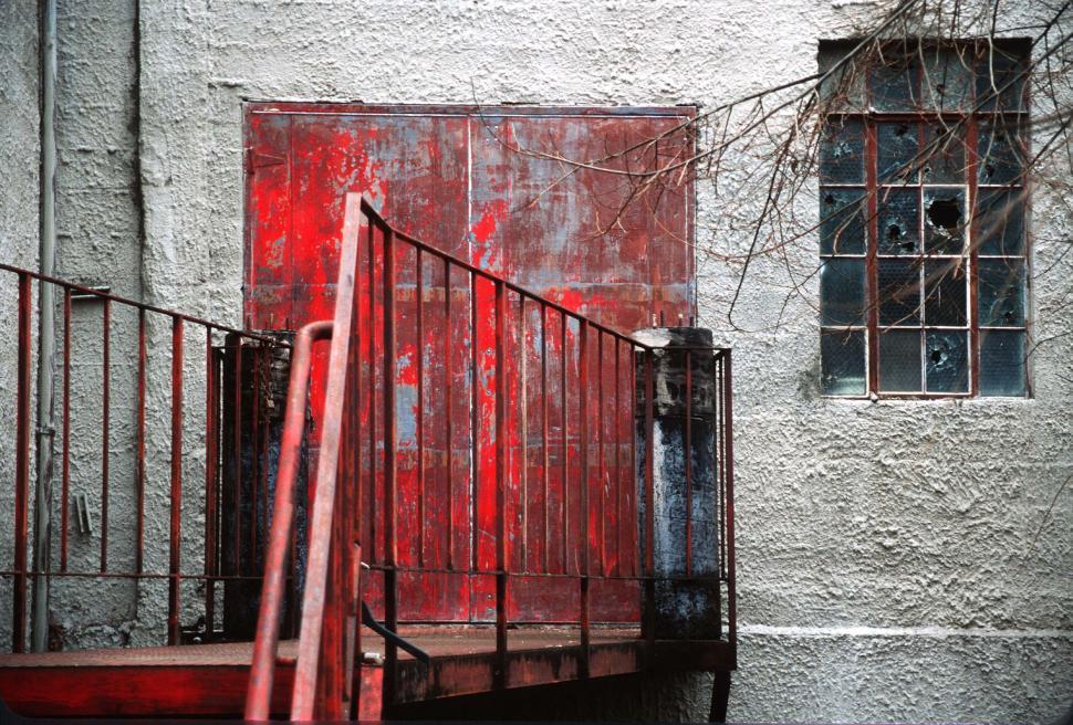 Free Image of Red metal doors at the top of the steps 