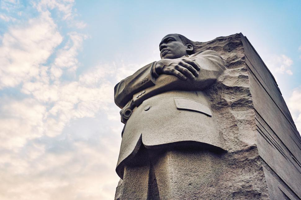 Free Image of Sculpture of Man in Suit with sky as background  