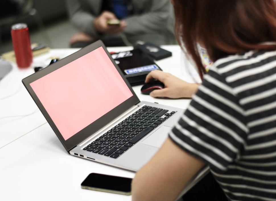 Free Image of A young woman working on her laptop - screen blanked out 