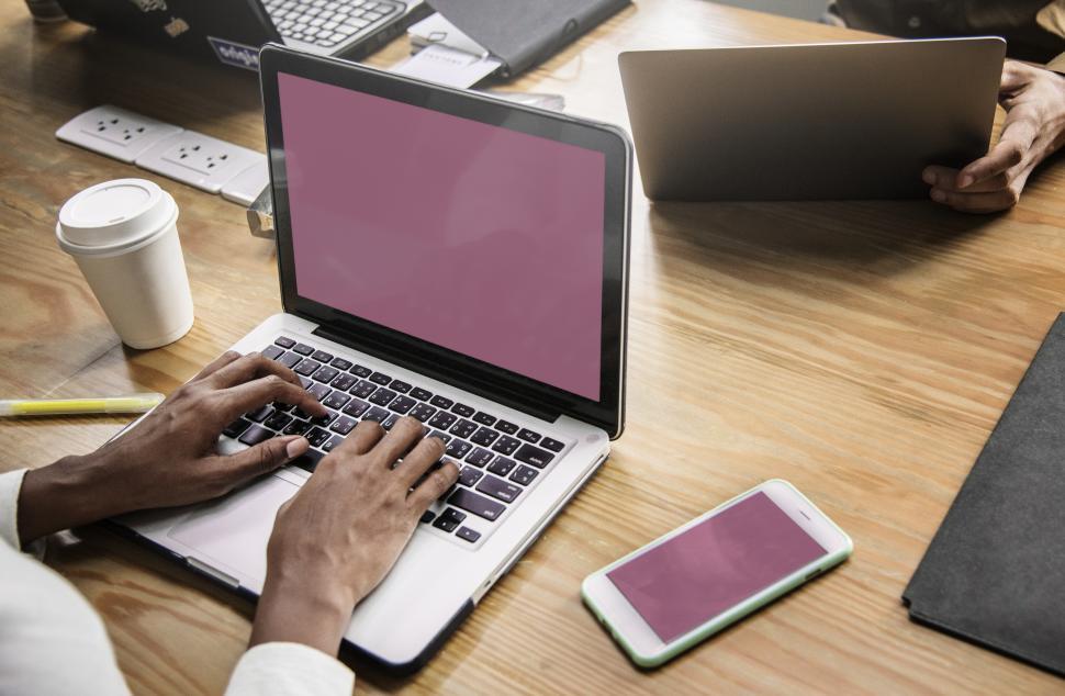 Free Image of Close up of a woman typing on a blank screen laptop 