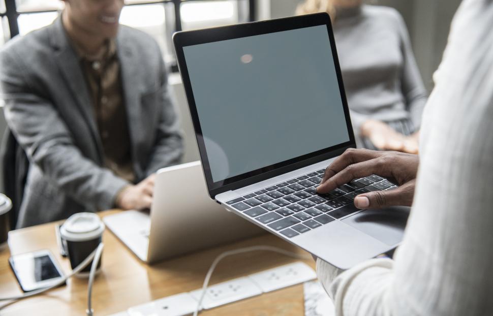 Free Image of Woman typing on the laptop with blank screen - ready for composite 