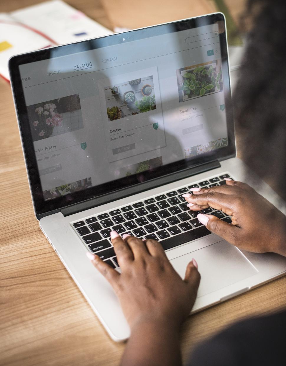 Free Image of Woman typing on the laptop with both hands 