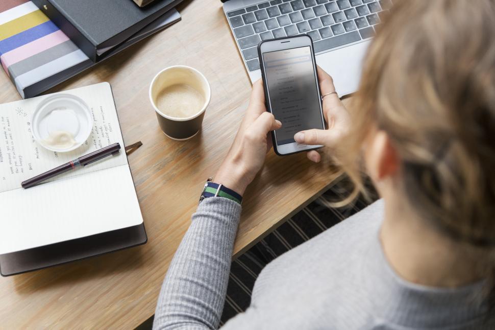 Free Image of Close up of a mobile phone in a young womans hands 