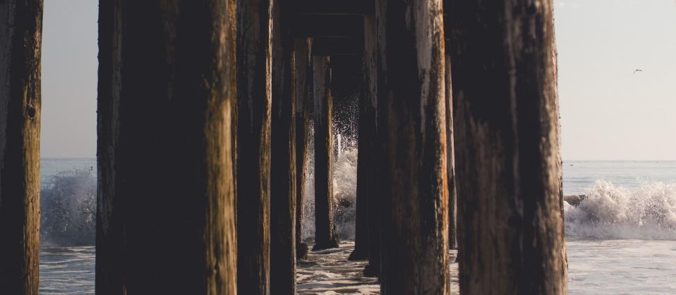 Free Image of Wooden Pillars and Ocean  