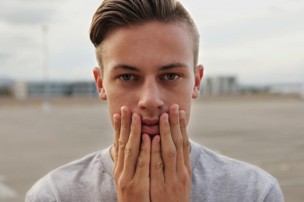 Free Image of Close up of Man Face with hands on cheeks 