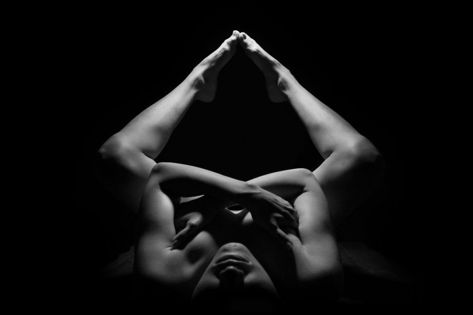 Free Image of Dark View of Woman in Naked Yoga Pose  