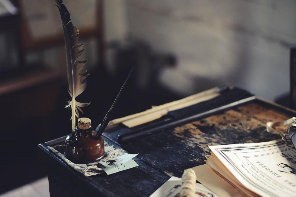 Free Image of Feather pen and ink pot on table  