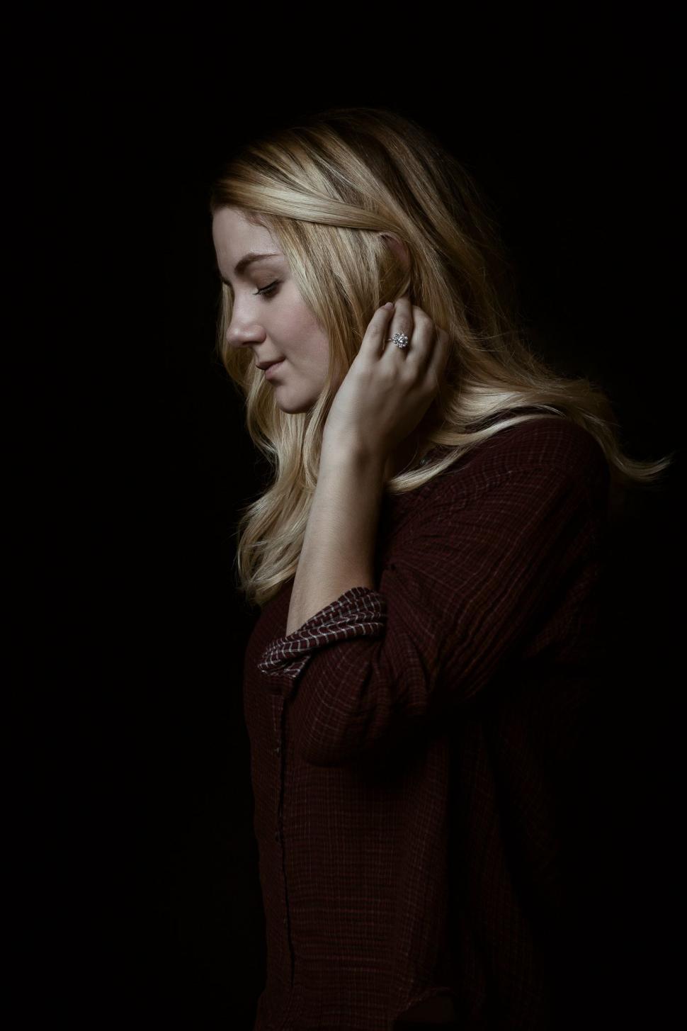 Free Image of Blonde Woman in Maroon Shirt - looking down  