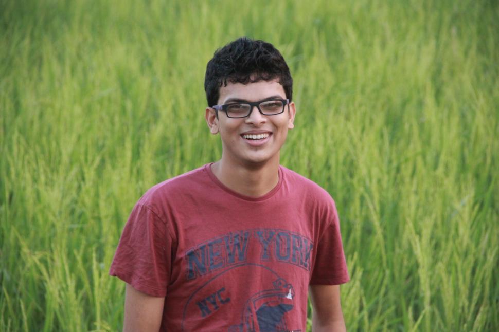 Free Image of Smiling Young Boy in Red T-shirt - Eye Contact  