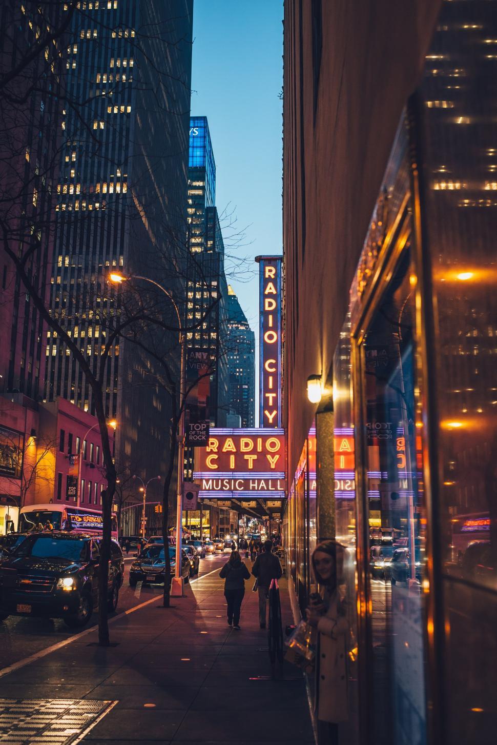 Free Image of Night Lights of Radio City Music Hall With Skyscrapers  