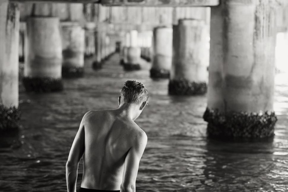 Free Image of Man and pier columns- B&W 