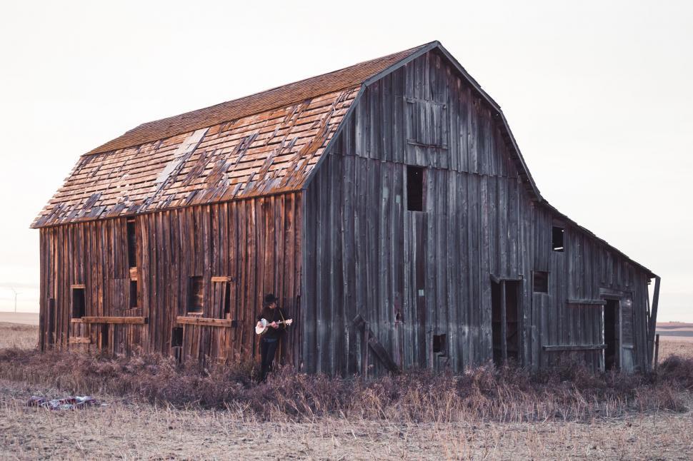 Free Image of Male Guitarist And Abandoned Farmhouse 