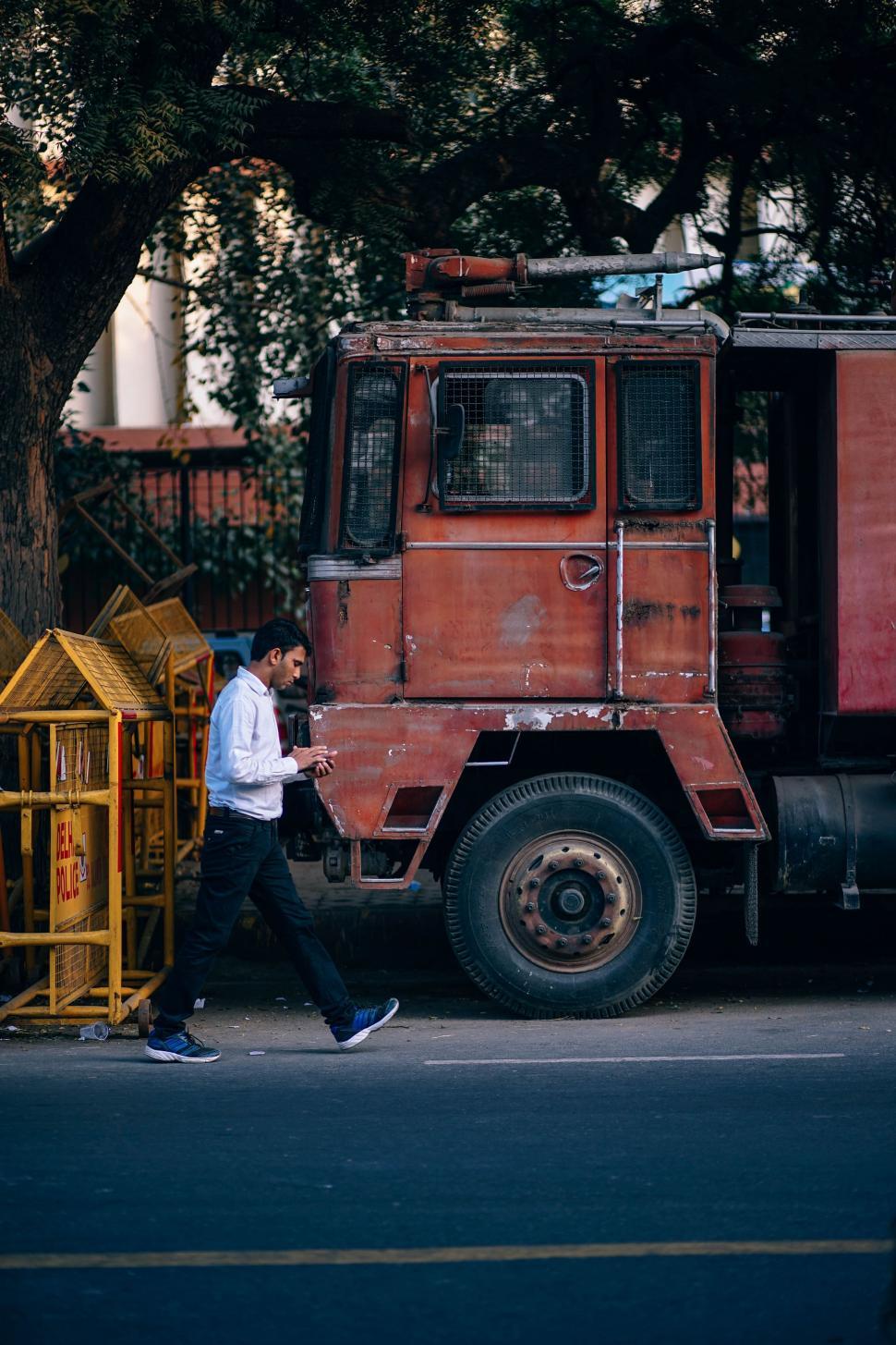 Free Image of Indian Man Walking on City Road 