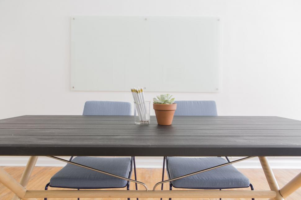 Free Image of Empty Chairs and Table with pot plant  
