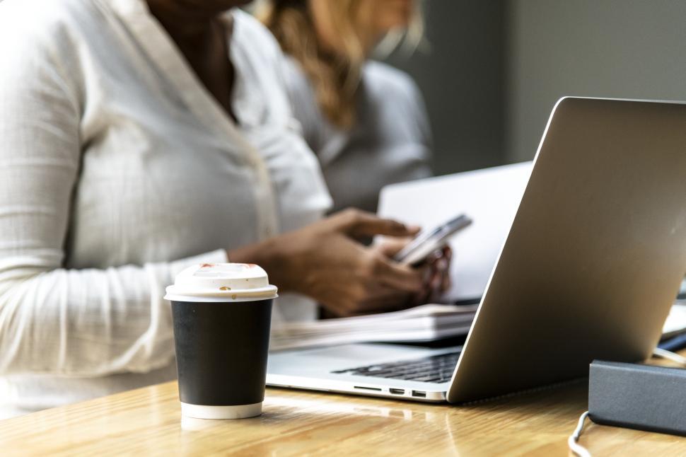 Free Image of Close up of a coffee mug on the table in a work area 