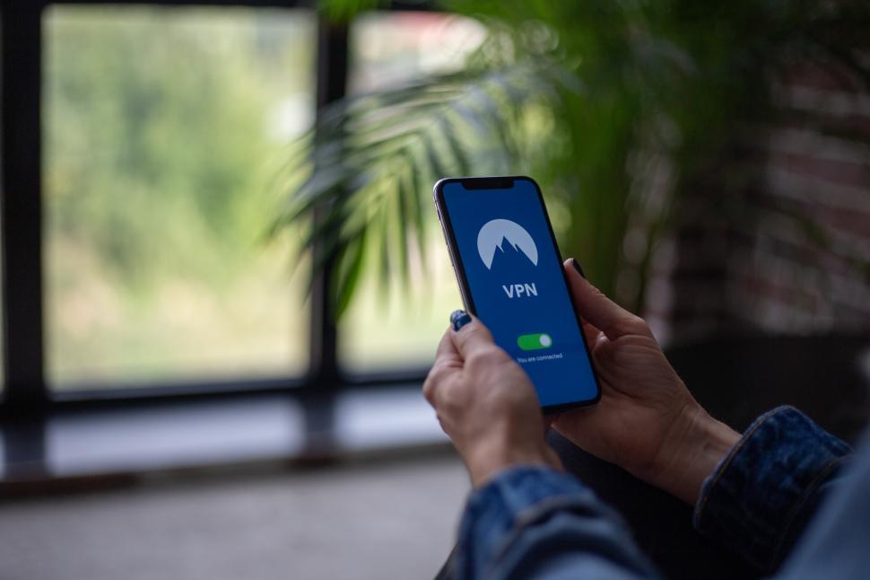 Free Image of Woman holding a smartphone in the office  