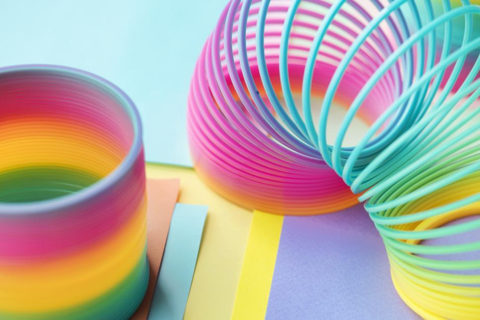 Free Image of Close up of colorful slinkys coiled and uncoiled 
